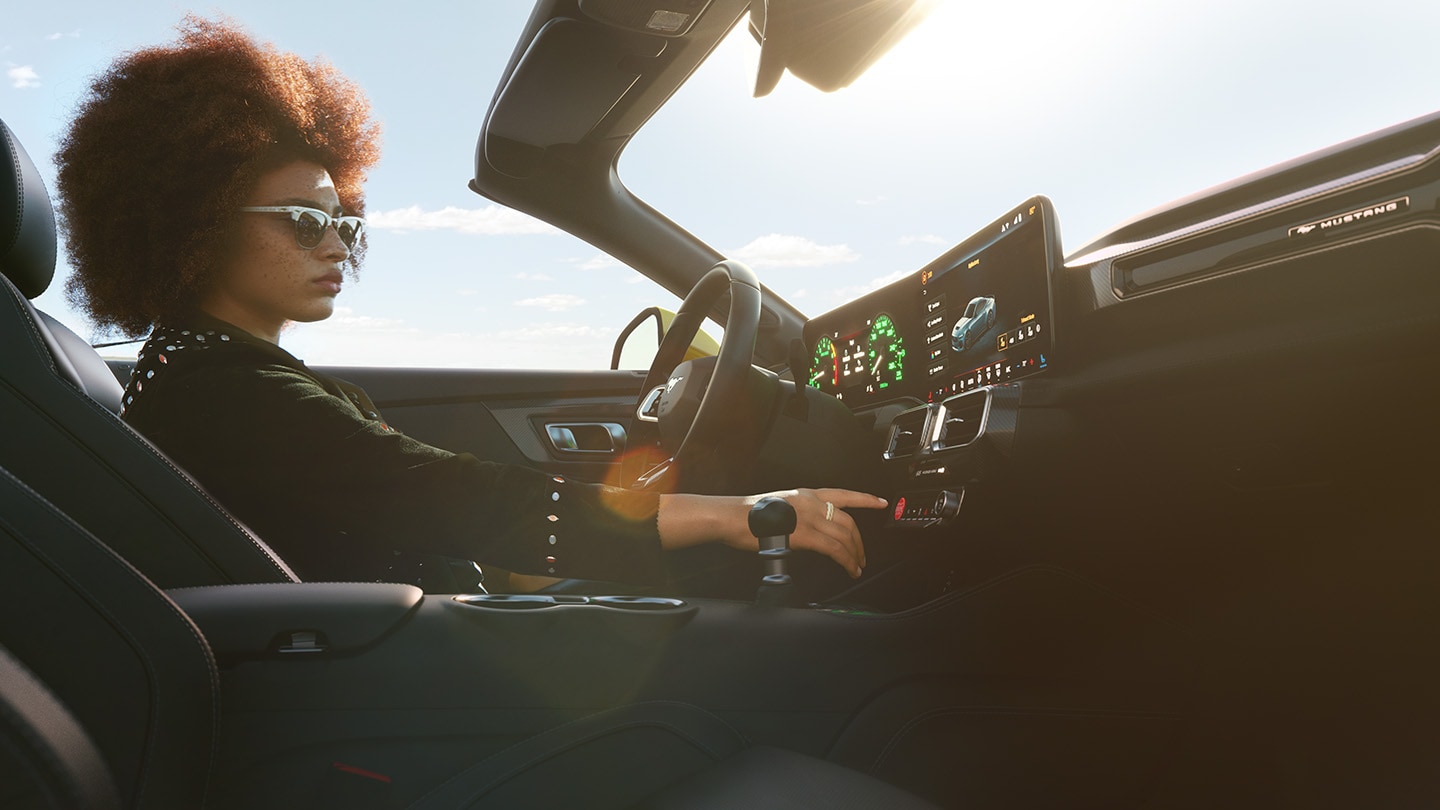 Person behind steering wheel in sunlit Mustang 